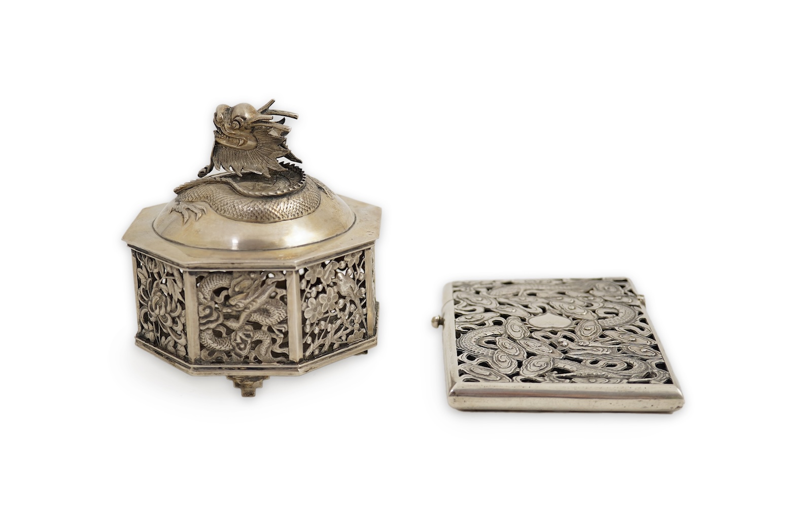 A late 19th century Chinese Export pierced silver card case, maker KMS(Kwong Man Shing), decorated with dragons amid clouds, 10.4cm, together with a Chinese Export pierced silver octagonal box and cover, by Luen Wo?, cir